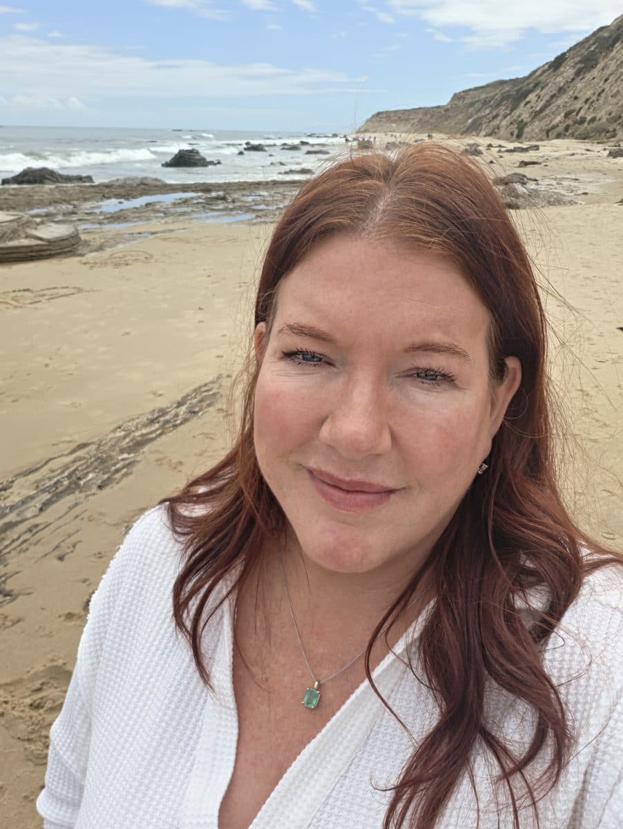 Kelly on the beach, smiling
